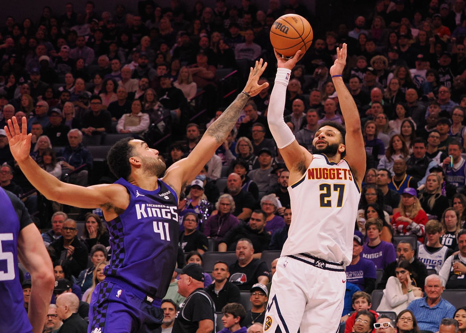 Feb 9, 2024; Sacramento, California, USA; Denver Nuggets guard Jamal Murray (27) shoots the ball against Sacramento Kings forward Trey Lyles (41) during the second quarter at Golden 1 Center. Mandatory Credit: Kelley L Cox-USA TODAY Sports  
